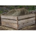 Hay net in the shape of a''Tablecloth'' in a bin